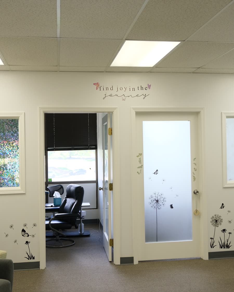 The Journey Therapy office interior with two doorways and Find Joy in the Journey wall lettering